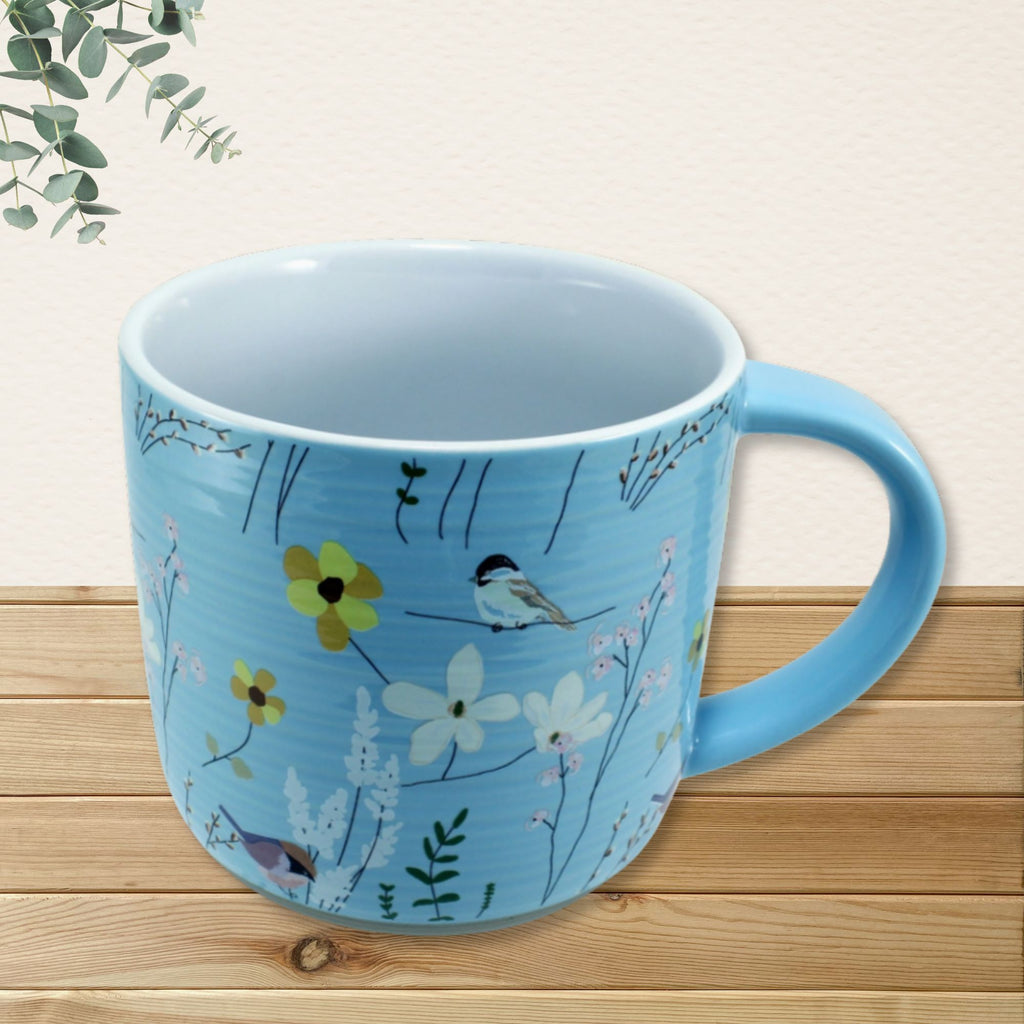 Sweet Friend mug exterior showing full bird and wildflower botanical design on sky blue background