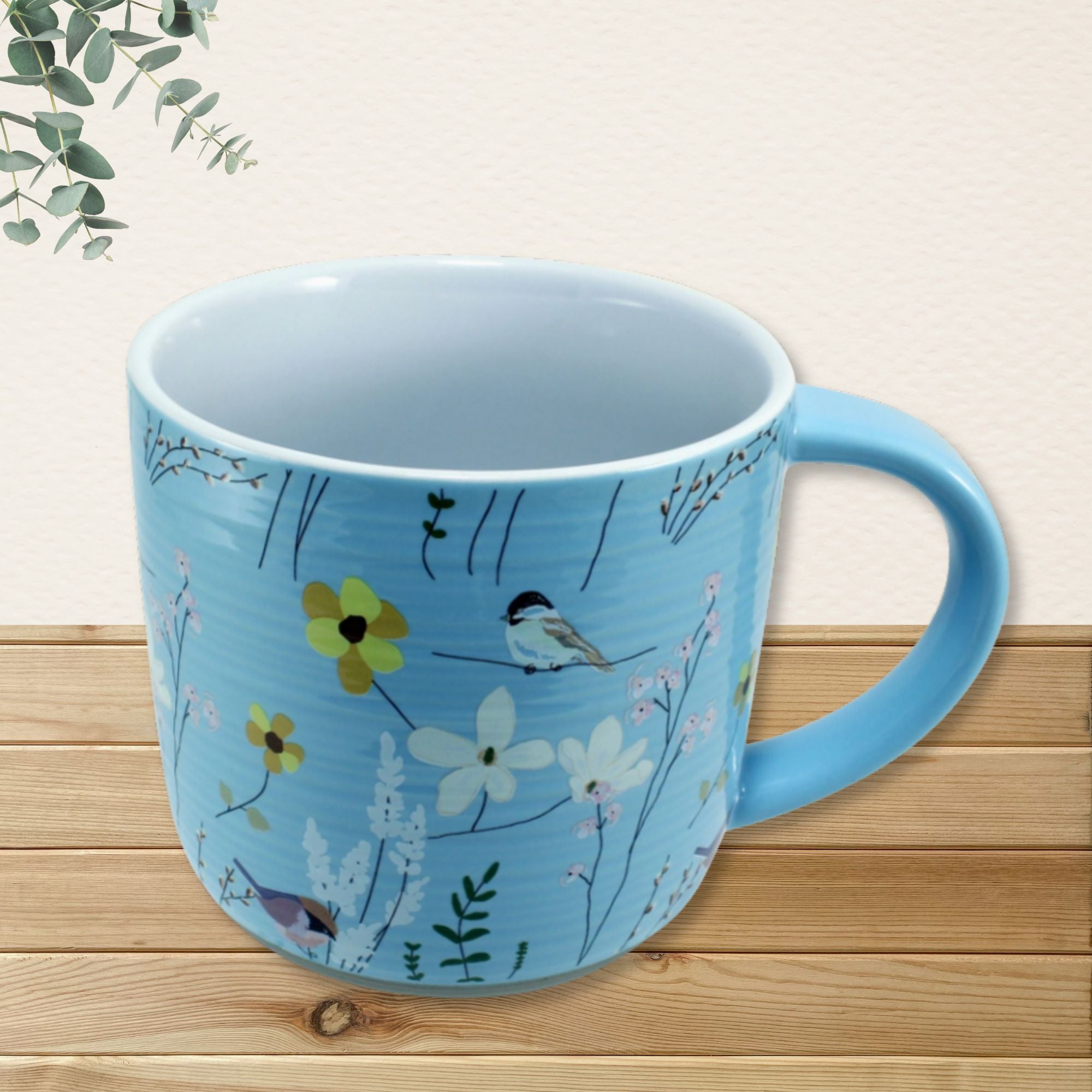 Sweet Friend mug exterior showing full bird and wildflower botanical design on sky blue background