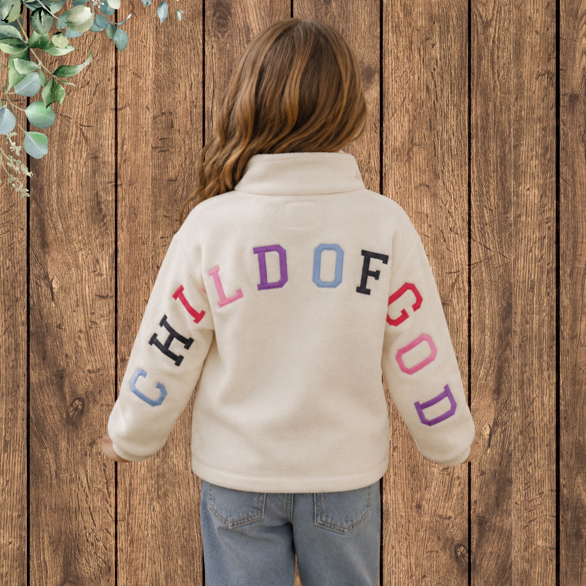 Girl wearing Child of God Children's Quarter-Zip Pullover - back lifestyle photo showing colorful embroidery