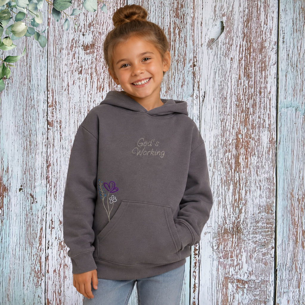 Girl wearing God's Working Children's Hoodie - front lifestyle photo