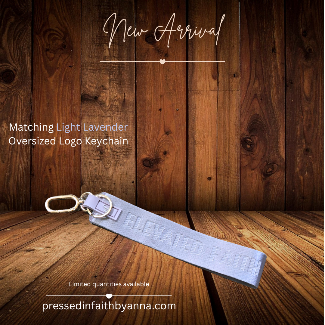 Light Lavender Oversized Logo Keychain by Elevated Faith on wooden background