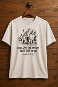 "Follow the Word Not the Herd Isaiah 8 Christian graphic tee — vintage cow, mountain, and cross design on heather oatmeal by Pressed in Faith by Anna"