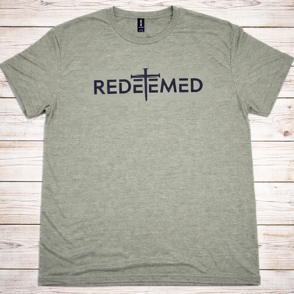 "Redeemed Cross Christian t-shirt in Heather Military Green — bold minimalist REDEEMED lettering with cross graphic by Pressed in Faith by Anna"