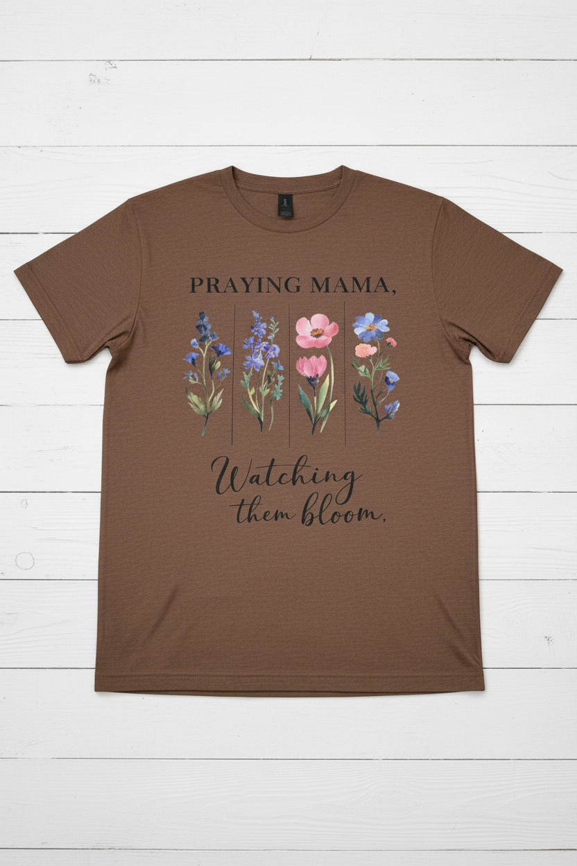 "Praying Mama Watching Them Bloom Christian t-shirt in Cocoa mist — watercolor wildflower graphic by Pressed in Faith by Anna"