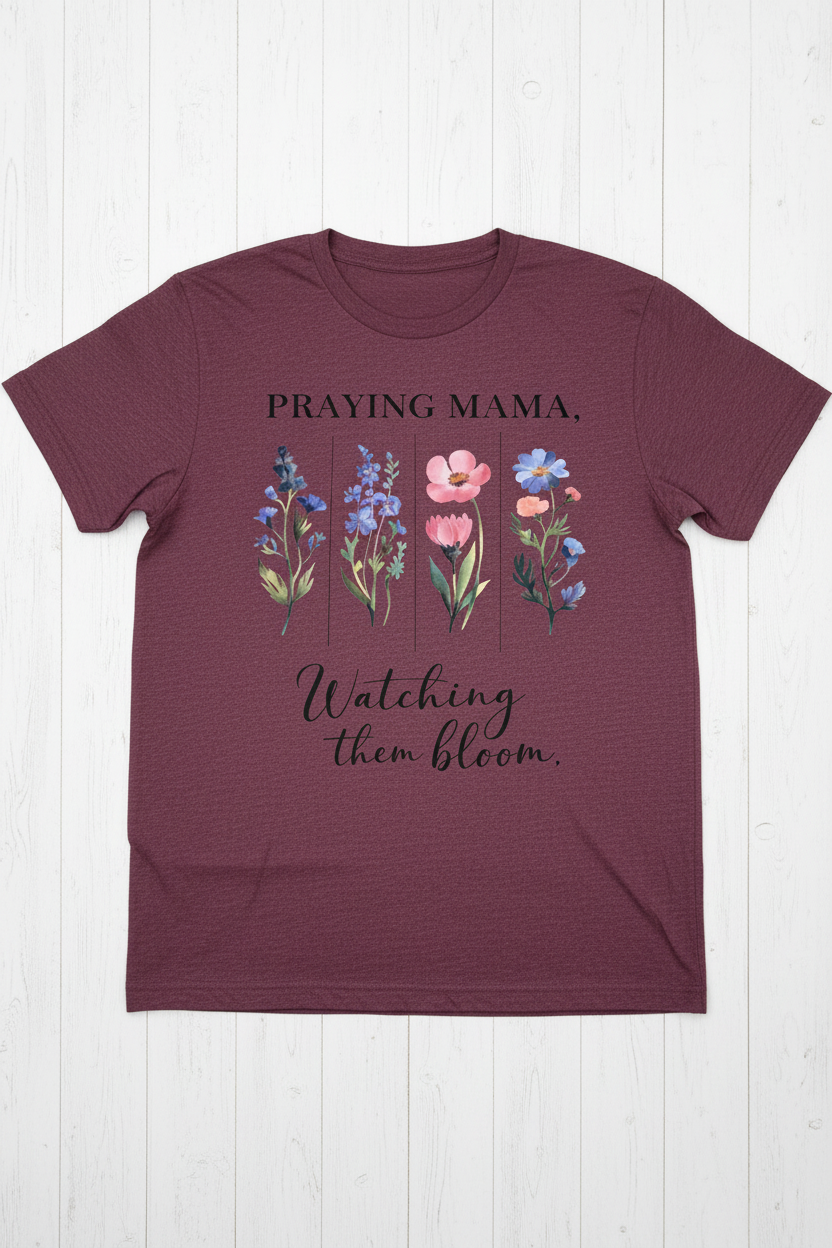 "Praying Mama Watching Them Bloom Christian t-shirt in Heather Maroon — watercolor wildflower graphic by Pressed in Faith by Anna"