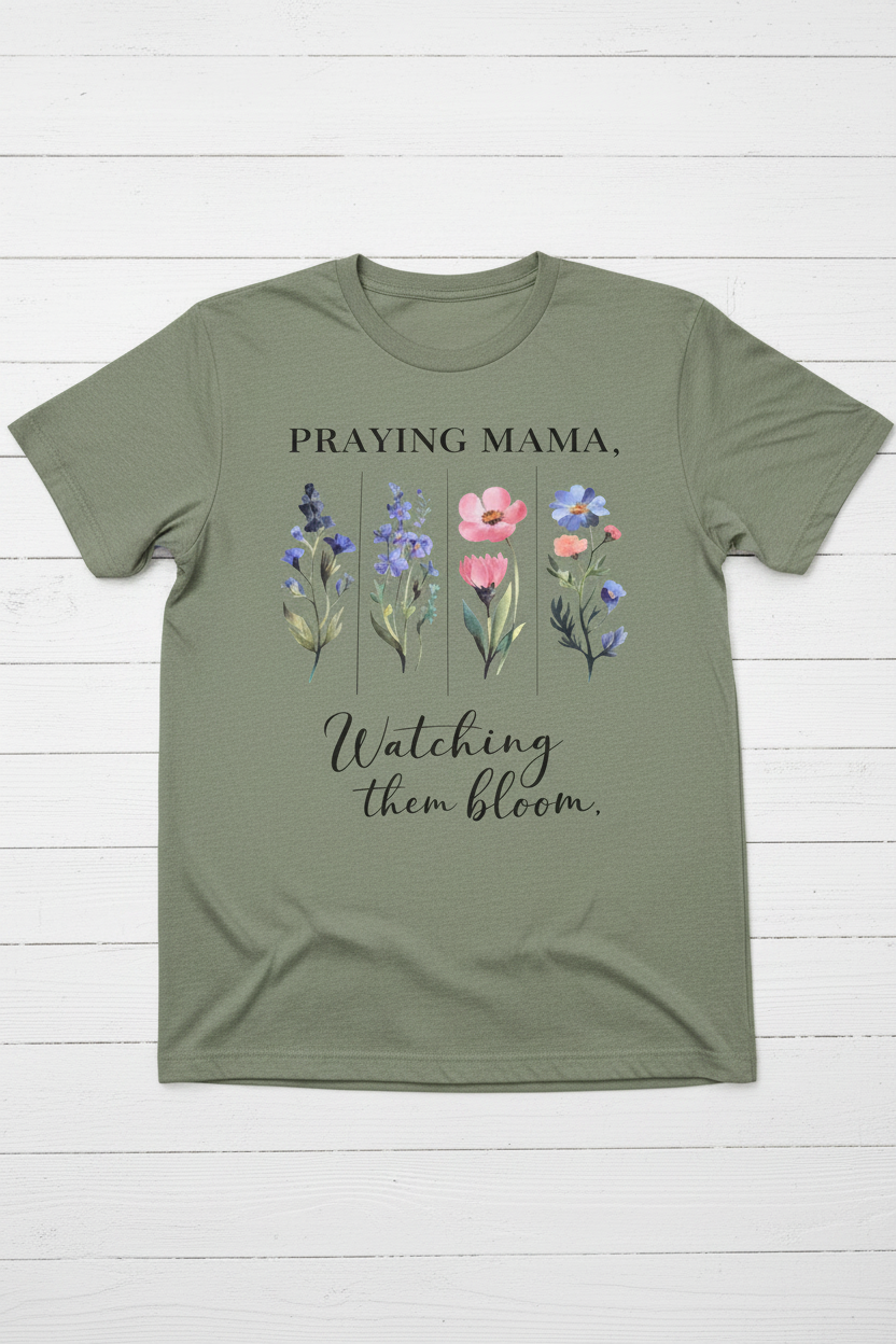 "Praying Mama Watching Them Bloom Christian t-shirt in Heather Military Green — watercolor wildflower graphic by Pressed in Faith by Anna"
